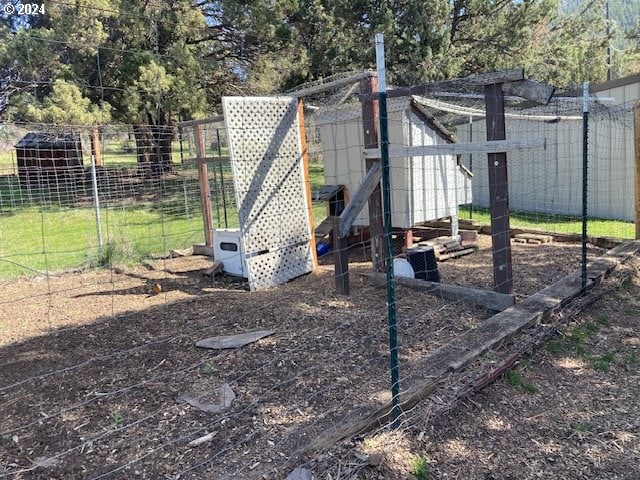 view of playground featuring an outbuilding