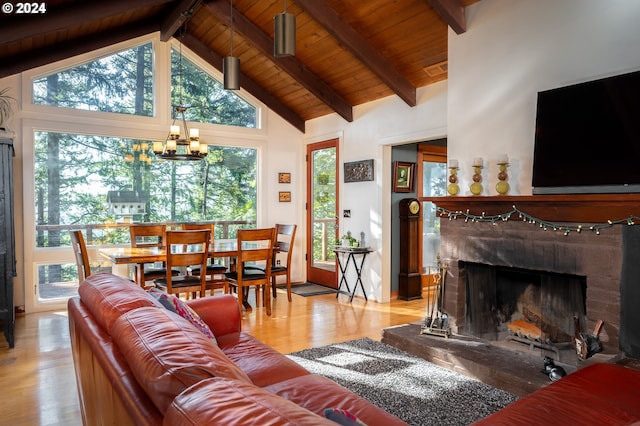 living room featuring a brick fireplace, a chandelier, and a wealth of natural light