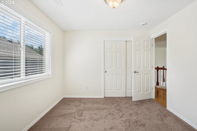 unfurnished bedroom featuring a closet and carpet floors