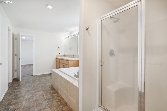 bathroom with vanity and separate shower and tub