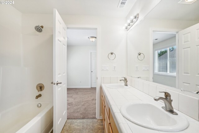 bathroom featuring tile patterned floors, bathing tub / shower combination, and vanity