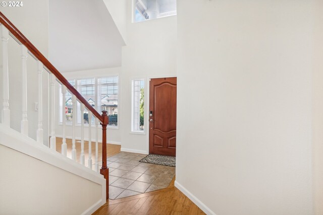 entrance foyer featuring light hardwood / wood-style flooring and a high ceiling