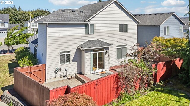 back of property featuring a patio area and a yard