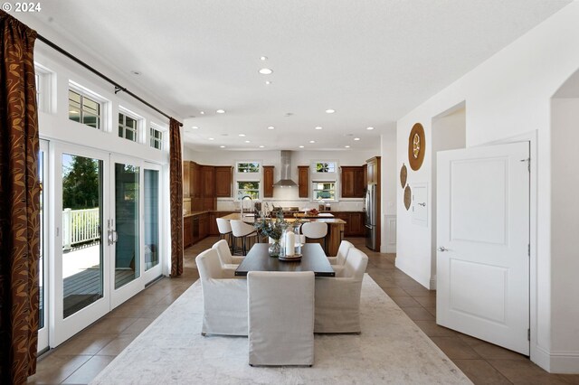 dining room featuring sink and light tile patterned floors