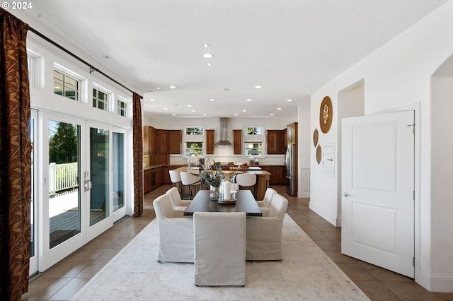 tiled dining area featuring recessed lighting, french doors, and a sink