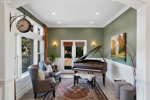 living area with crown molding and light tile patterned flooring