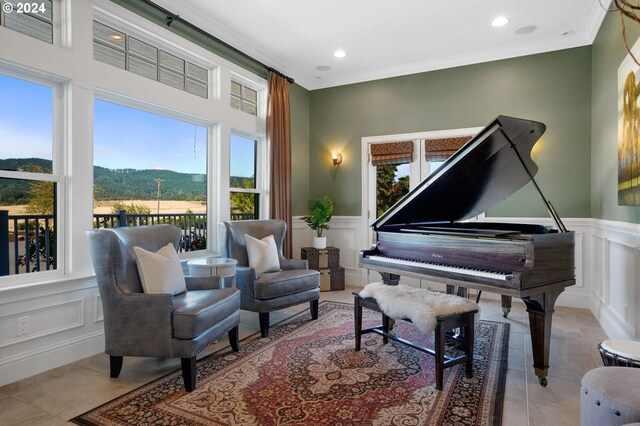 living area featuring a wealth of natural light, a mountain view, ornamental molding, and light tile patterned flooring