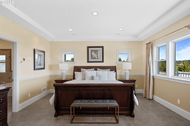 bedroom featuring light tile patterned floors and connected bathroom