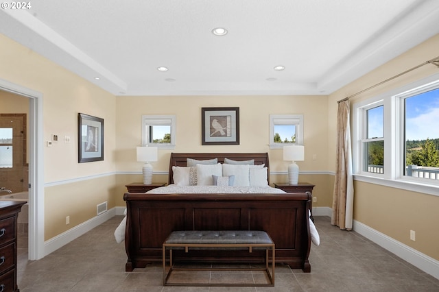 bedroom with a tray ceiling, light tile patterned flooring, recessed lighting, and baseboards