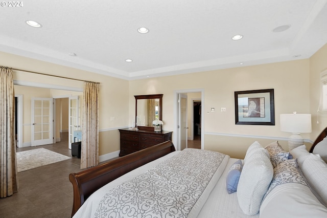 bedroom featuring recessed lighting, french doors, a raised ceiling, and baseboards