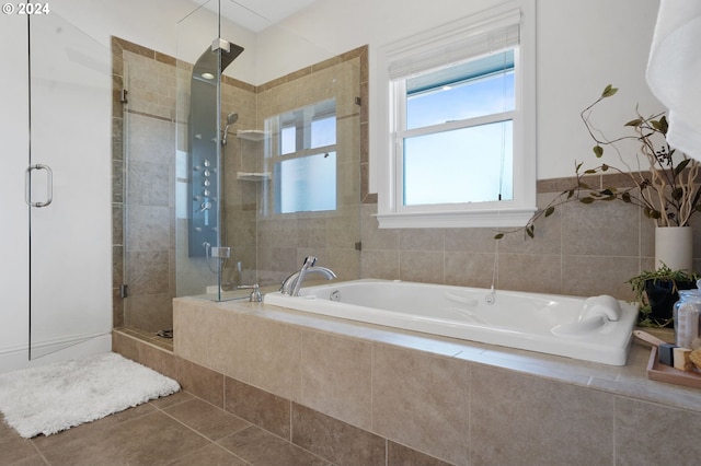 bathroom with a garden tub, a stall shower, and tile patterned flooring