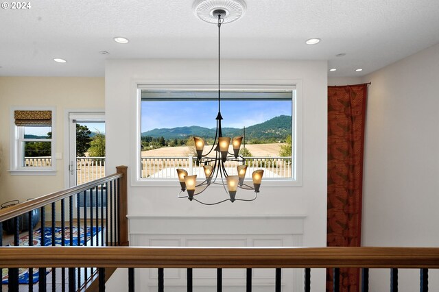 room details with a mountain view, an inviting chandelier, and a textured ceiling