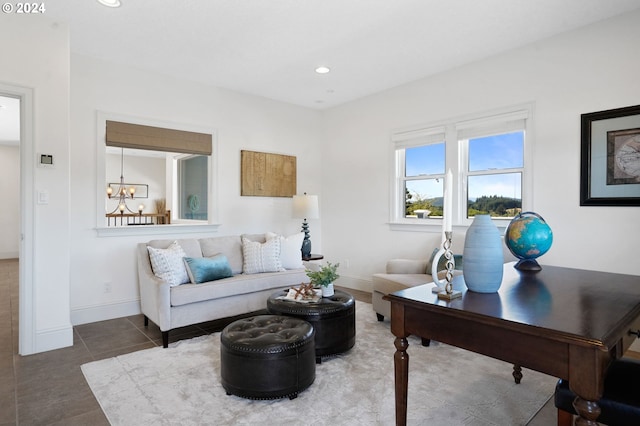 living room with an inviting chandelier, recessed lighting, baseboards, and tile patterned floors