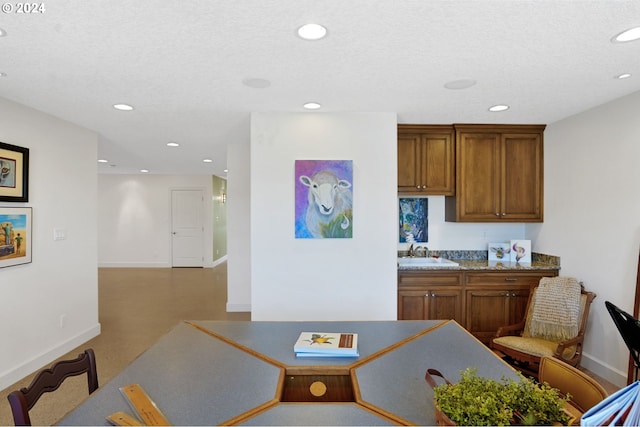 dining room with recessed lighting, a textured ceiling, and baseboards