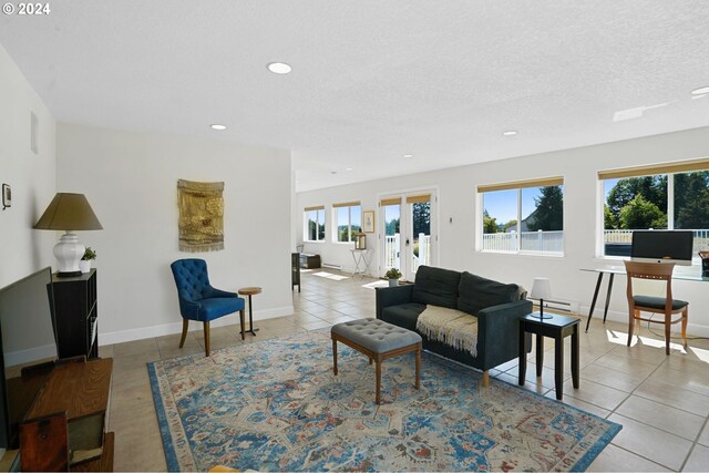 living room featuring french doors, a textured ceiling, and light tile patterned floors