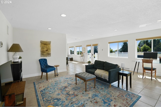 tiled living room featuring recessed lighting, a healthy amount of sunlight, baseboards, and a textured ceiling