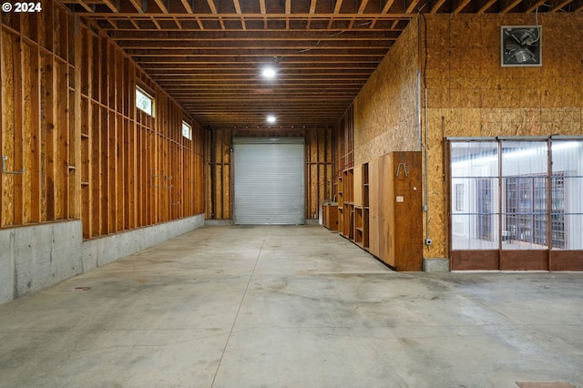 misc room with unfinished concrete floors and a garage