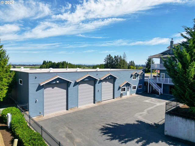 view of front of property with an outdoor structure and a garage