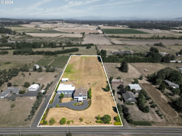 birds eye view of property with a rural view