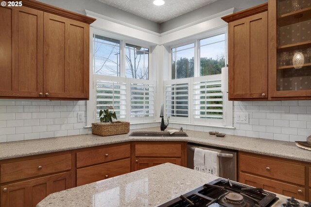 kitchen with dark wood-type flooring, sink, hanging light fixtures, a wealth of natural light, and stainless steel appliances