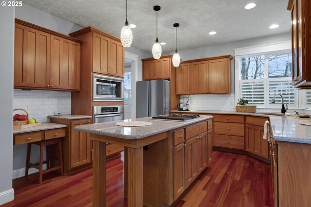 kitchen featuring dishwasher, light stone countertops, sink, and tasteful backsplash