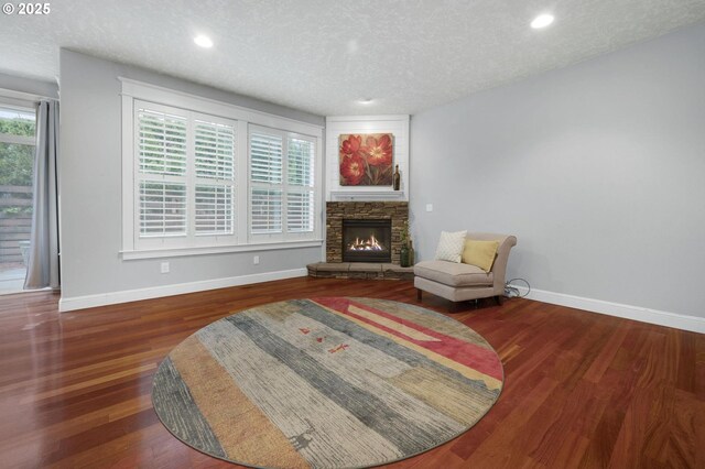 interior space featuring a wealth of natural light, dark hardwood / wood-style flooring, and a textured ceiling