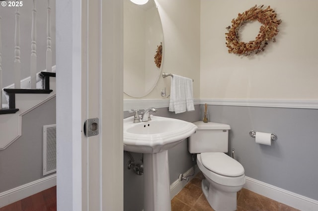 bathroom with tile patterned flooring, toilet, and sink