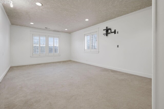 bedroom featuring crown molding, light colored carpet, and a textured ceiling