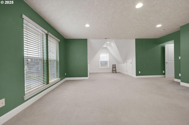 interior space with light colored carpet and a textured ceiling