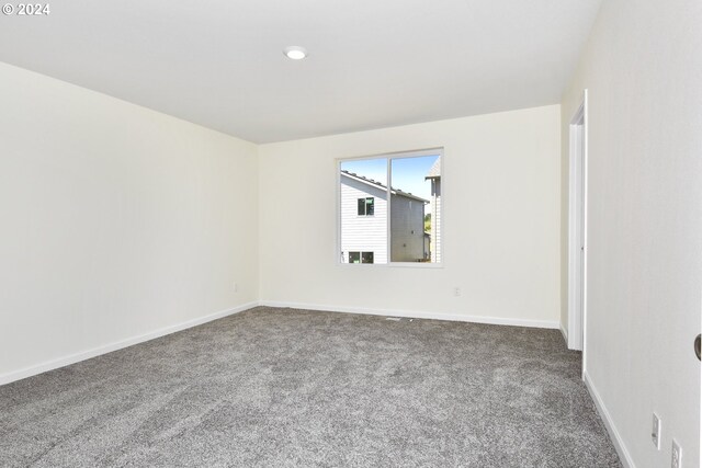 unfurnished room featuring carpet