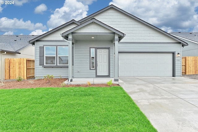 view of front of property with a garage and a front lawn