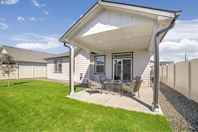 back of house featuring a patio and a yard