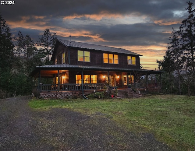 view of front of house featuring covered porch and a lawn