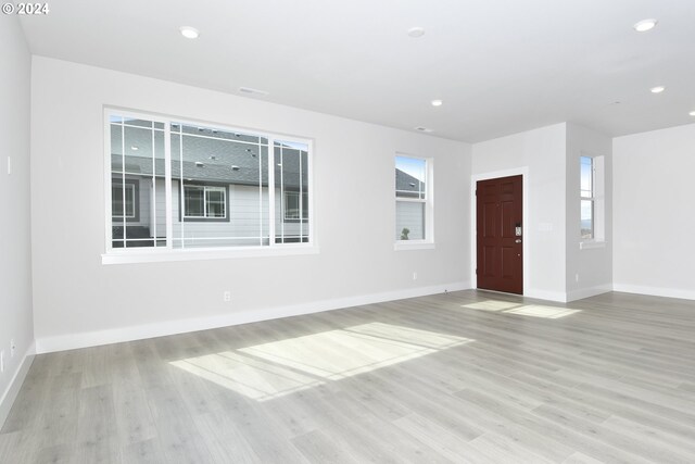 spare room featuring light wood-type flooring