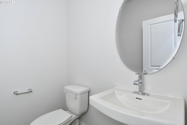 bathroom featuring toilet and sink