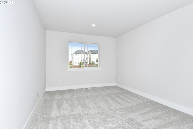 empty room featuring light colored carpet