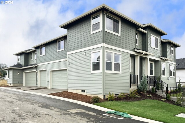 view of front of property with a front yard and a garage