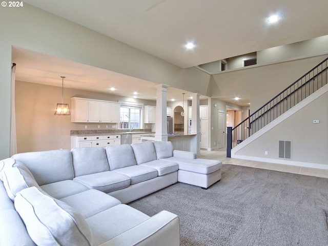 living room featuring light carpet and sink