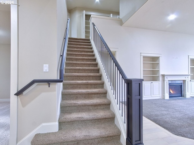 stairs featuring carpet and built in features