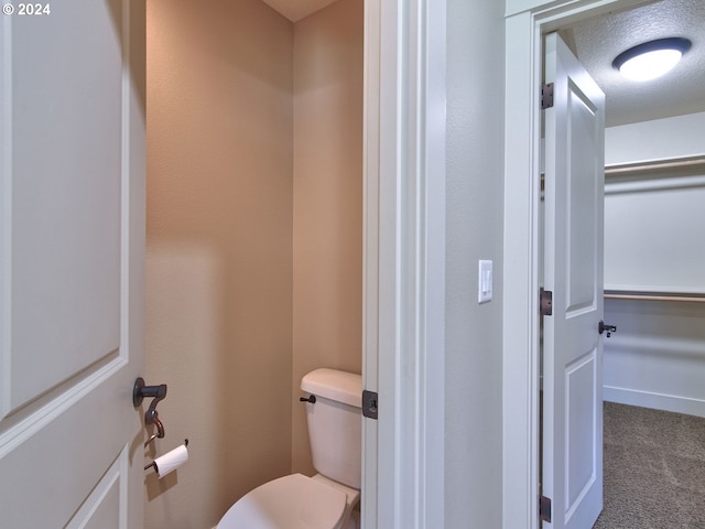 bathroom featuring a textured ceiling and toilet