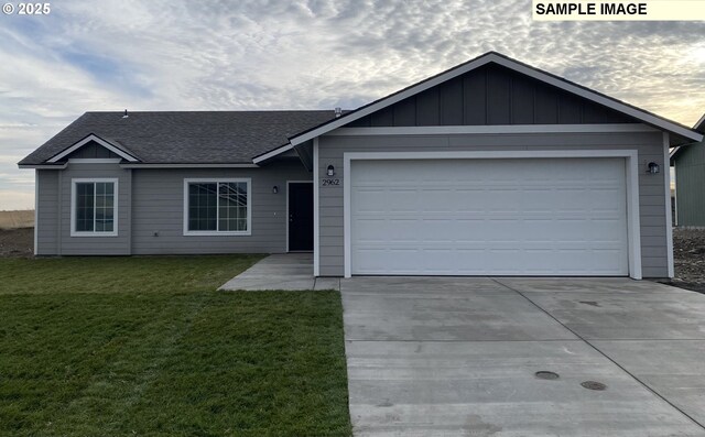 view of front of property with a garage and a front lawn