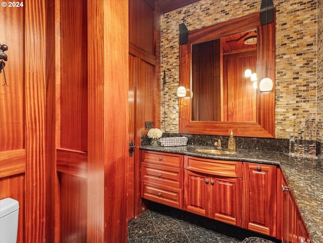 bathroom with vanity, toilet, and backsplash