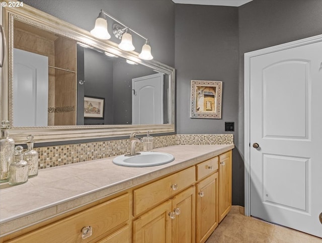 bathroom with vanity, tasteful backsplash, and tile patterned floors