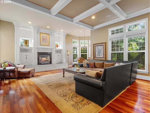 living room featuring beam ceiling, a healthy amount of sunlight, hardwood / wood-style flooring, and coffered ceiling