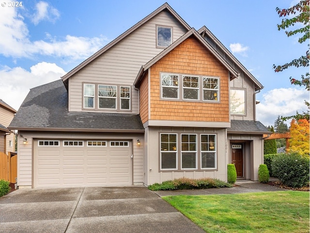 view of front facade featuring a front lawn and a garage