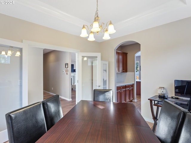 dining space with a chandelier and hardwood / wood-style flooring