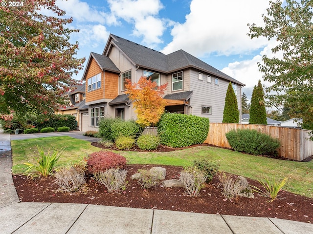 view of front of property with a garage and a front lawn