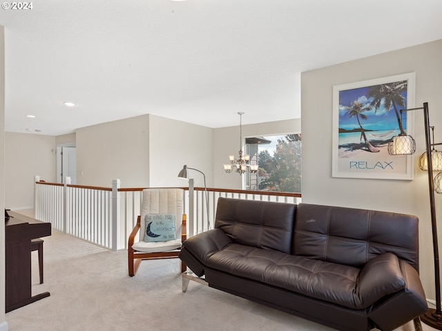 carpeted living room with a chandelier