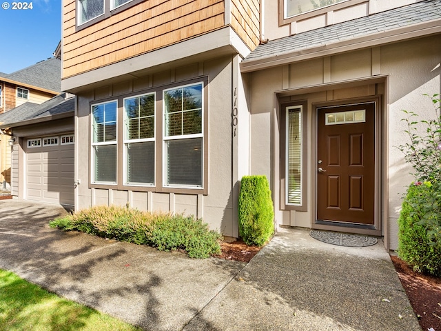 view of exterior entry with a garage