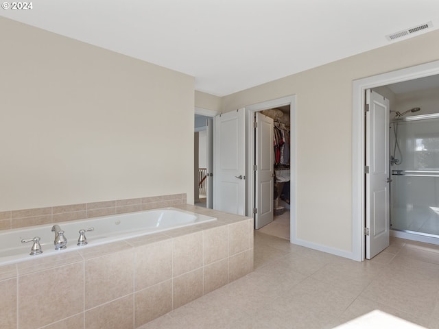 bathroom featuring tile patterned flooring and separate shower and tub